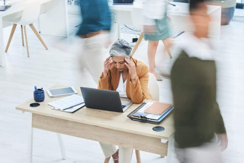 Busy,Office,,Stress,And,Senior,Woman,With,Headache,,Crisis,Or